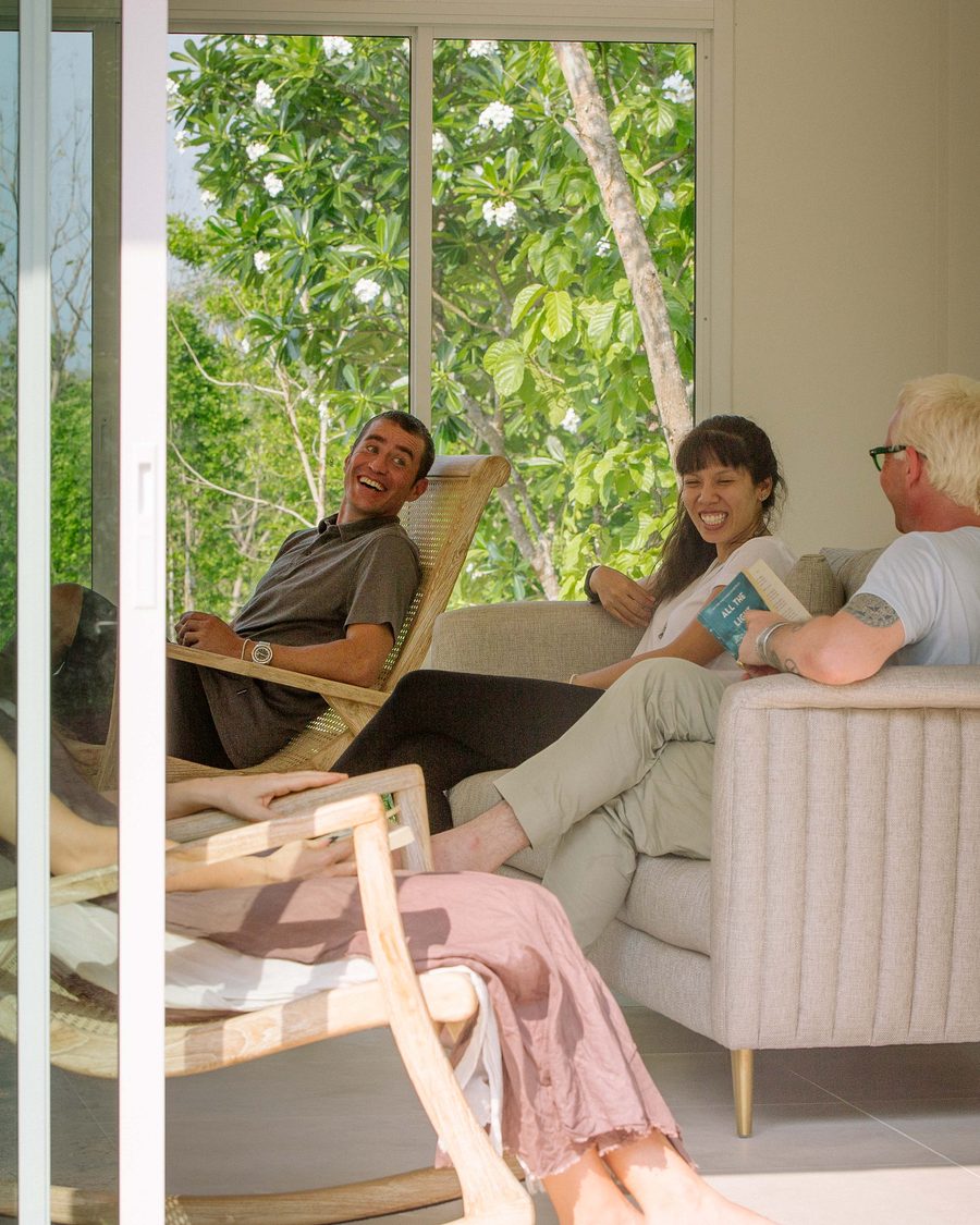 Clients talking and laughing together in the sunlit sala lounge