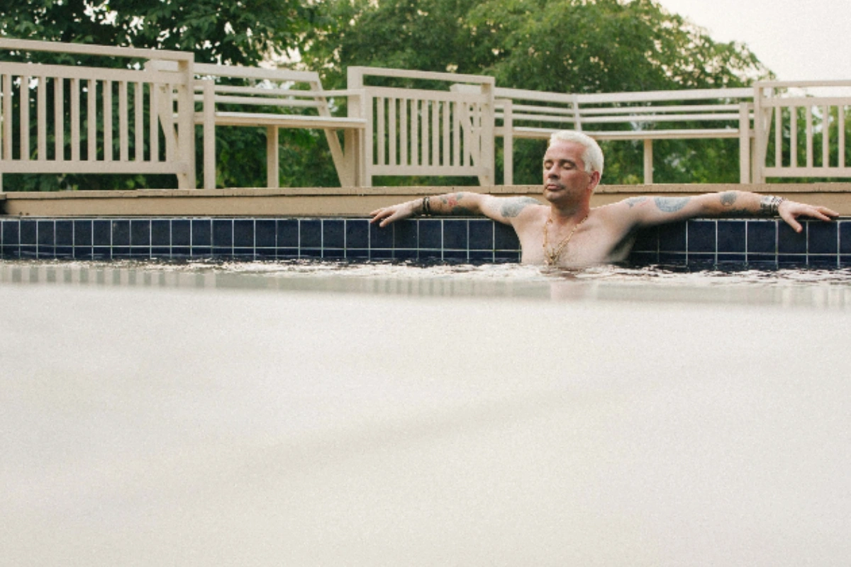 Man relaxing in a pool at a residential rehab in Thailand, benefiting from a serene environment away from triggers during addiction recovery.