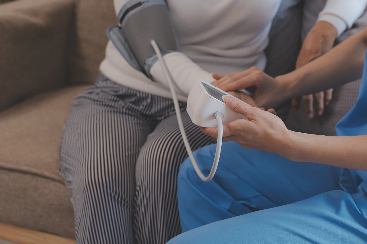 Nurse monitoring vital signs during medically supervised alcohol detox in Thailand