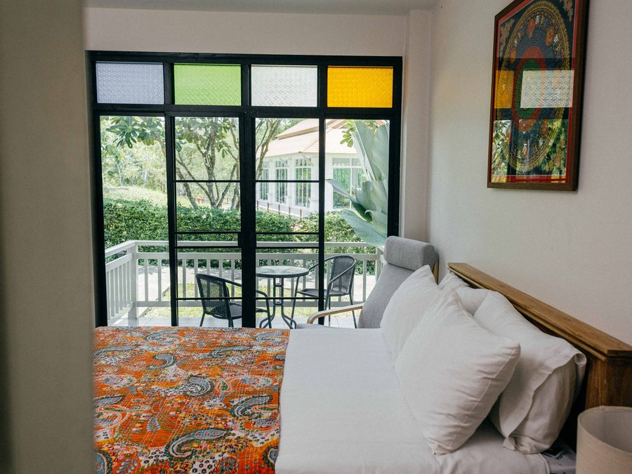 A bedroom with the shutters open to the morning