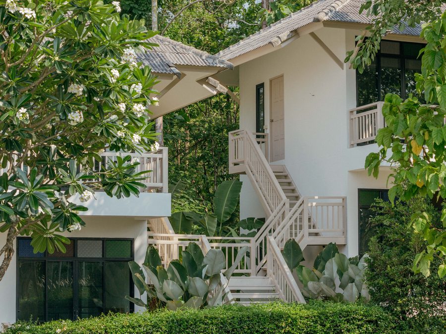 A villa in the grounds, with frangipani in flower beside the steps