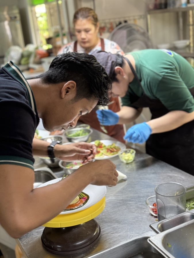 The kitchen team plating a dish