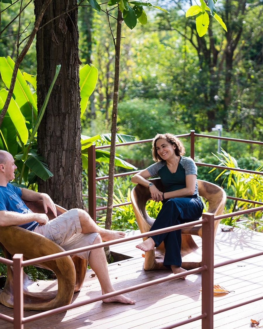 Two clients in conversation on the deck in the gardens