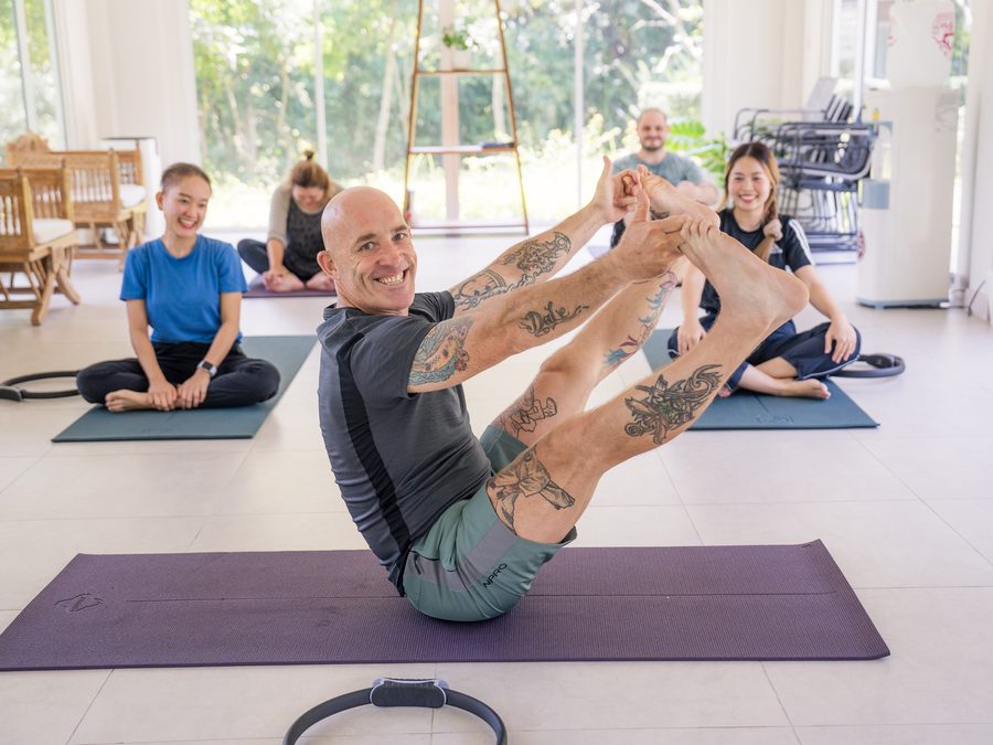 A group yoga class in the sala, mats laid out on the floor