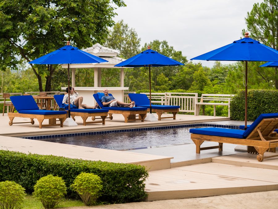 The pool and sun terrace, with loungers under parasols