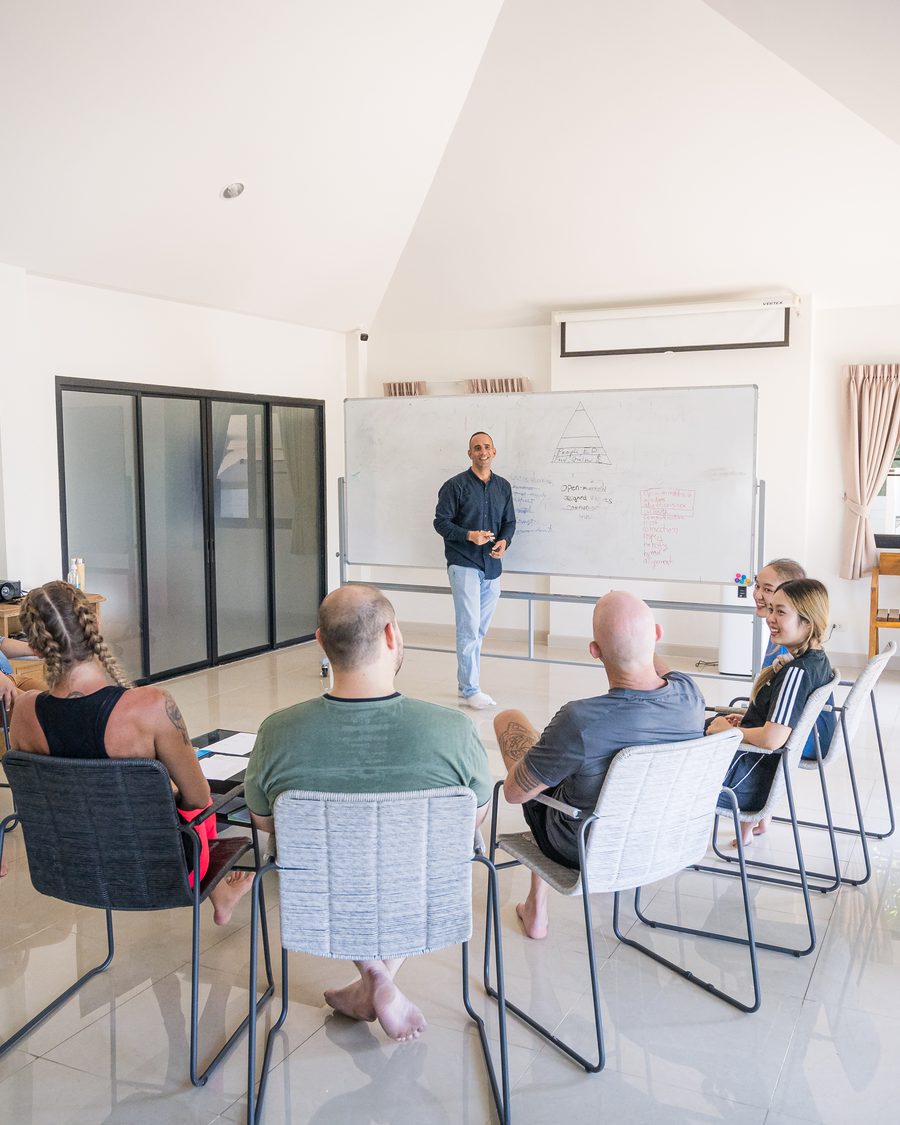 A counsellor leading a group therapy session in the recreation sala