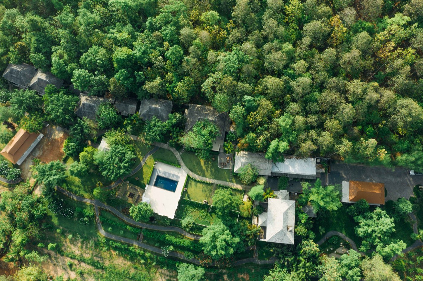 The centre seen from above: villas, salas and the pool terrace set in two hectares of trees
