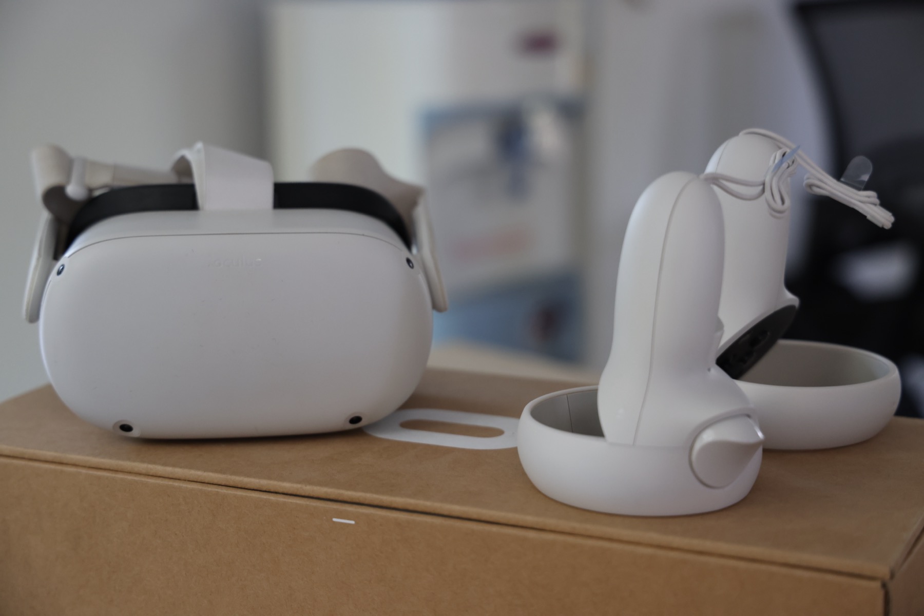 A virtual reality headset and its two controllers, set down ready for a session